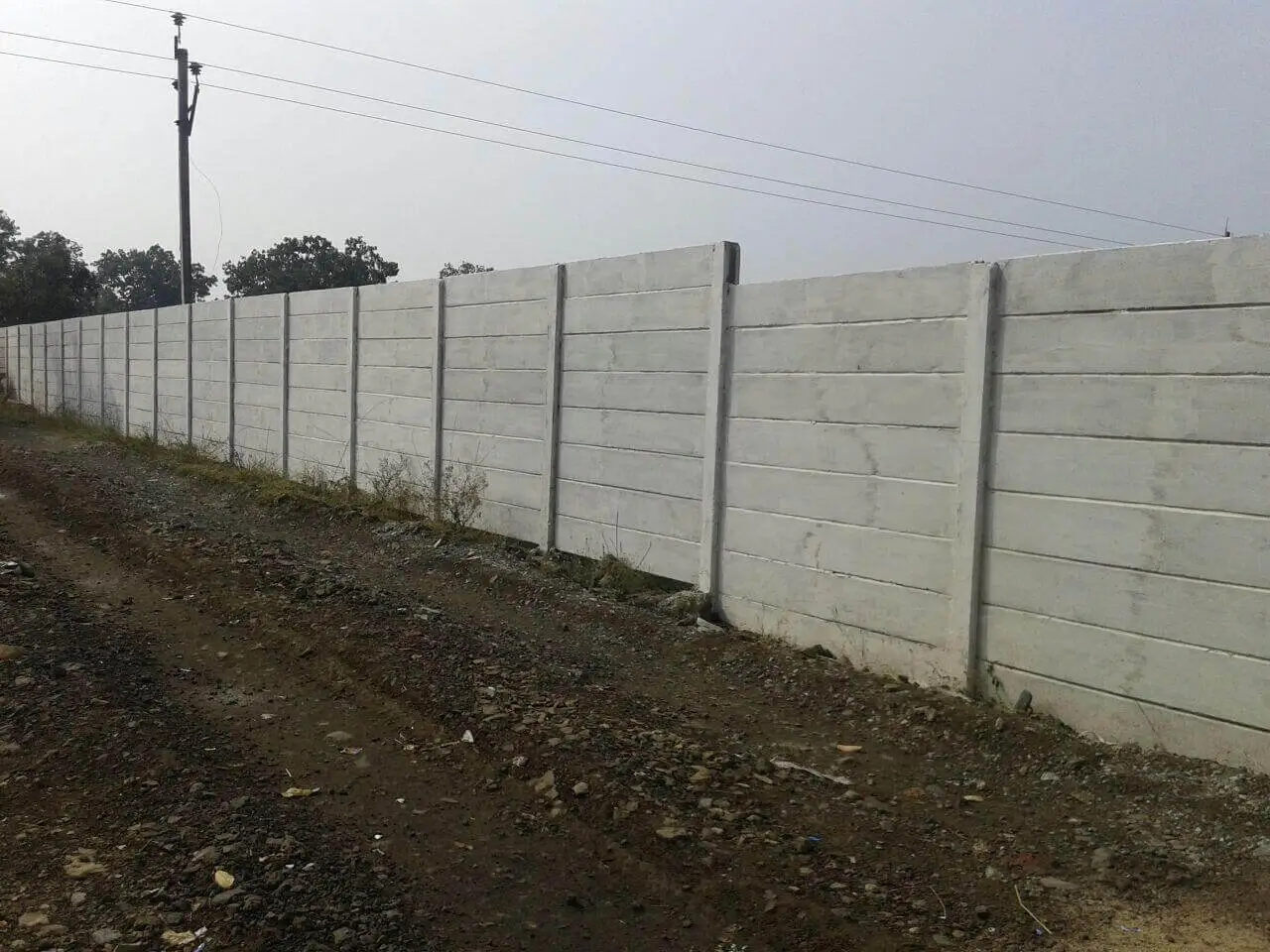 Precast compound wall along a roadside plot